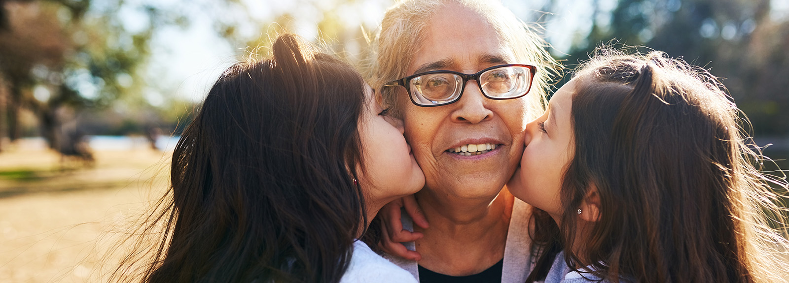 Cropped shot of a grandmother getting kissed on the cheeks by her two adorable granddaughters