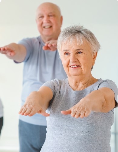 a senior couple doing stretches and exercises